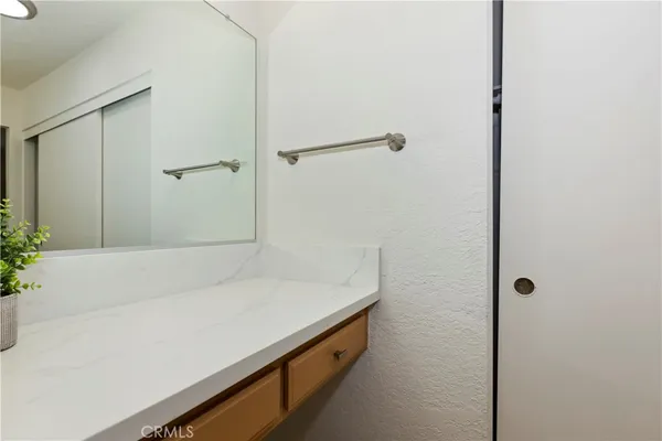 a spacious bathroom with a sink and a mirror