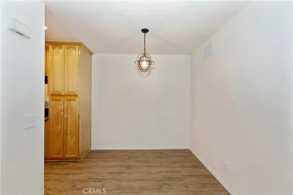 a kitchen with granite countertop cabinets and a wooden floor