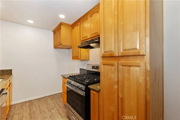 a kitchen with a sink a stove and cabinets