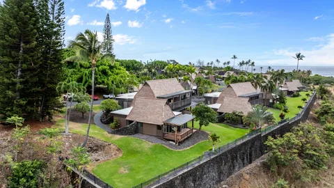 an aerial view of a house with garden space and street view