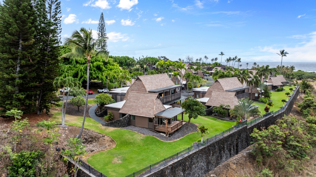 an aerial view of a house with garden space and street view