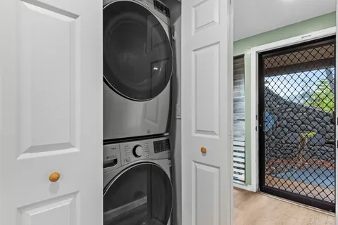 a view of a hallway with washer and dryer
