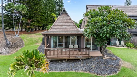 a view of a house with a yard and sitting area