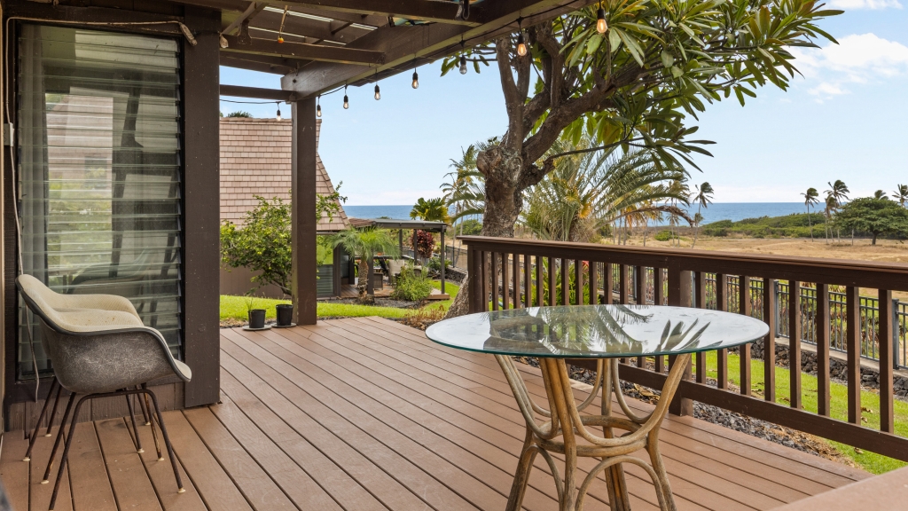95-789 Ninole Loop Road, Unit 42 Naalehu, HI 96772 - Photo 2 of 30 a view of a balcony with chair and wooden floor