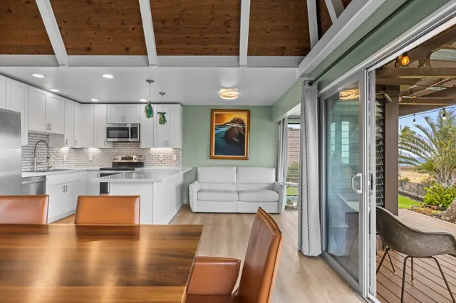 a kitchen with stainless steel appliances granite countertop wooden floors a refrigerator and a stove