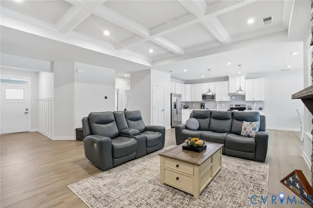 a living room with furniture and wooden floor