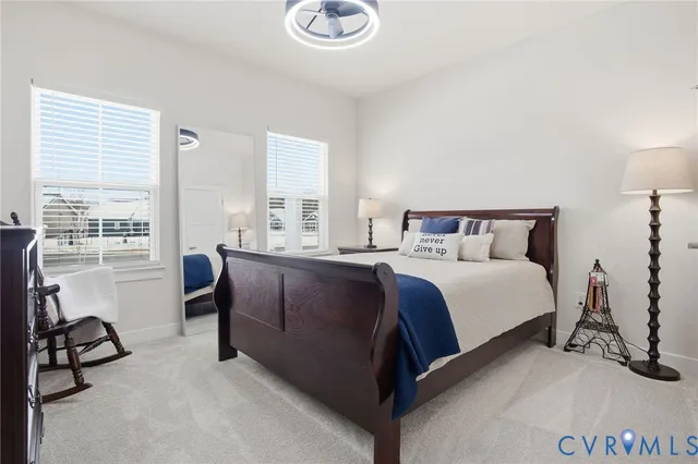 a bedroom with a bed a couch and a window