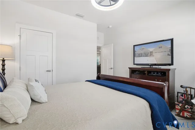 a bedroom with a bed and a flat screen tv