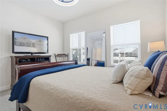a bedroom with a bed and glass windows