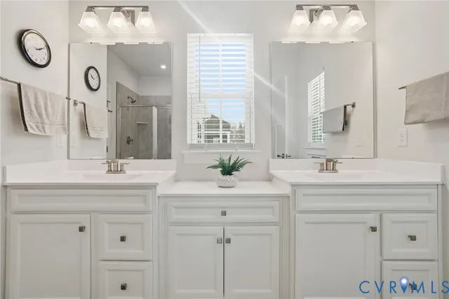 a bathroom with a sink vanity and a mirror