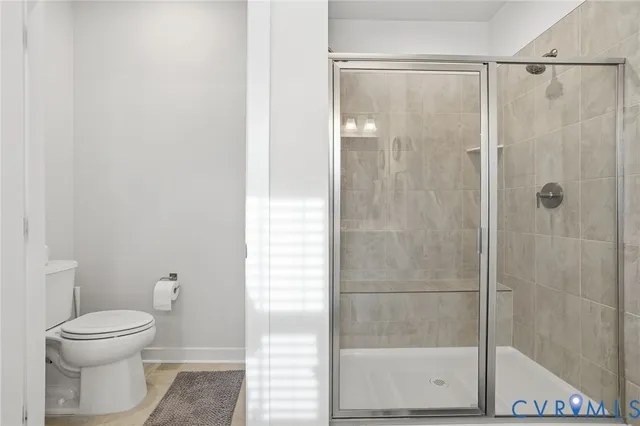 a bathroom with a shower and a toilet