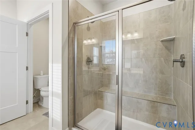 a bathroom with a glass shower door
