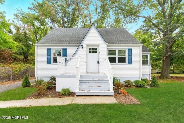 a front view of a house with a garden and yard