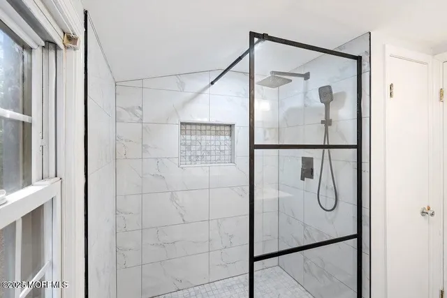 a bathroom with a glass shower door