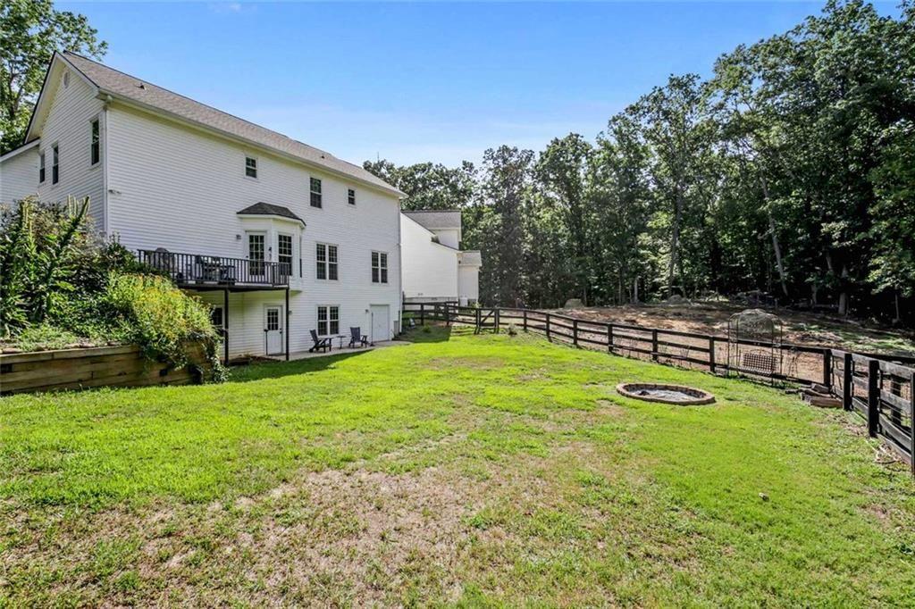 2203 Arbor Hill Road Canton, GA 30115 - Photo 13 of 65 a view of a house with swimming pool and a yard