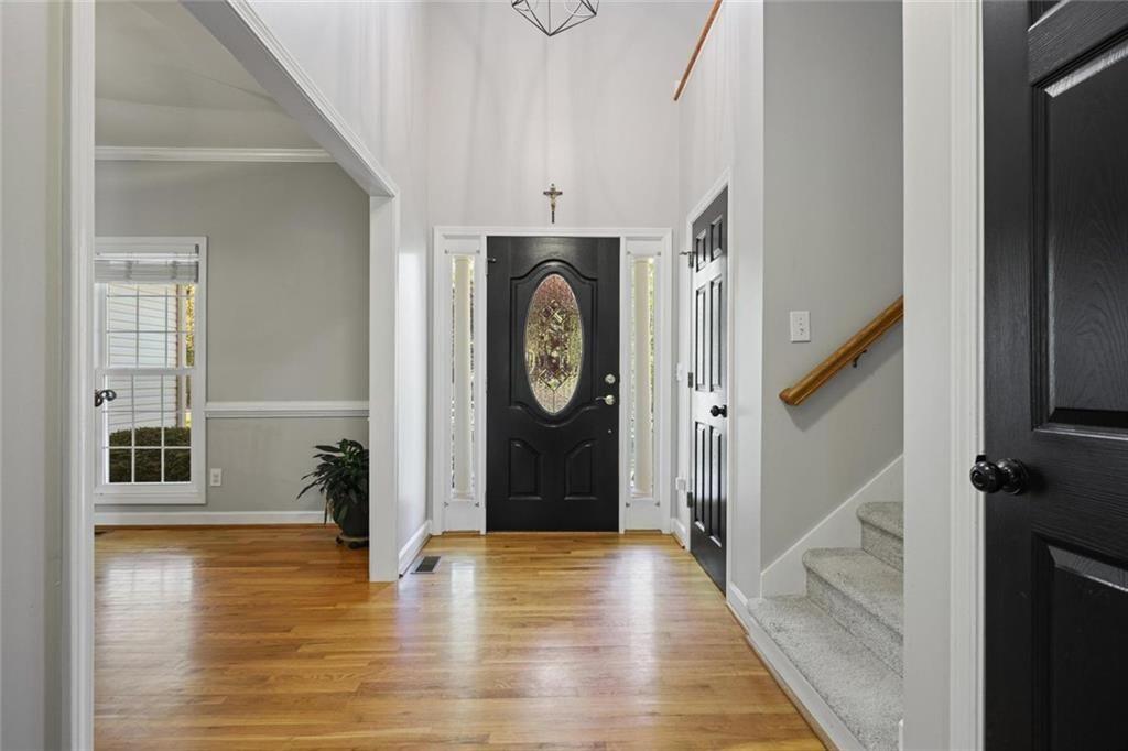 2203 Arbor Hill Road Canton, GA 30115 - Photo 27 of 65 a view of a hallway with entryway wooden floor and front door