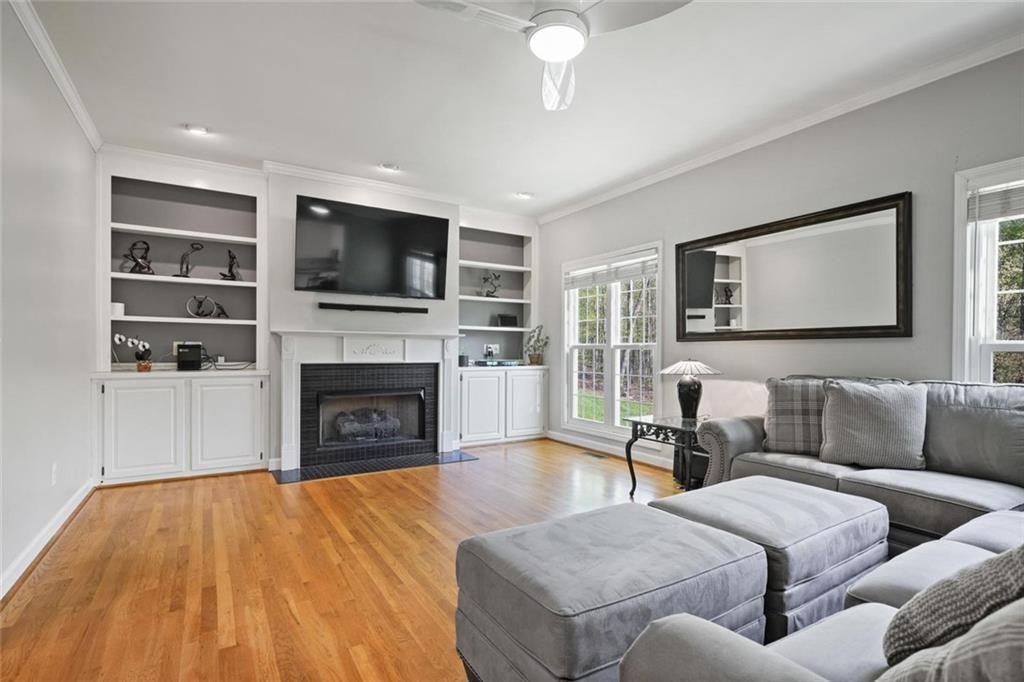2203 Arbor Hill Road Canton, GA 30115 - Photo 30 of 65 a living room with furniture a flat screen tv and a fireplace