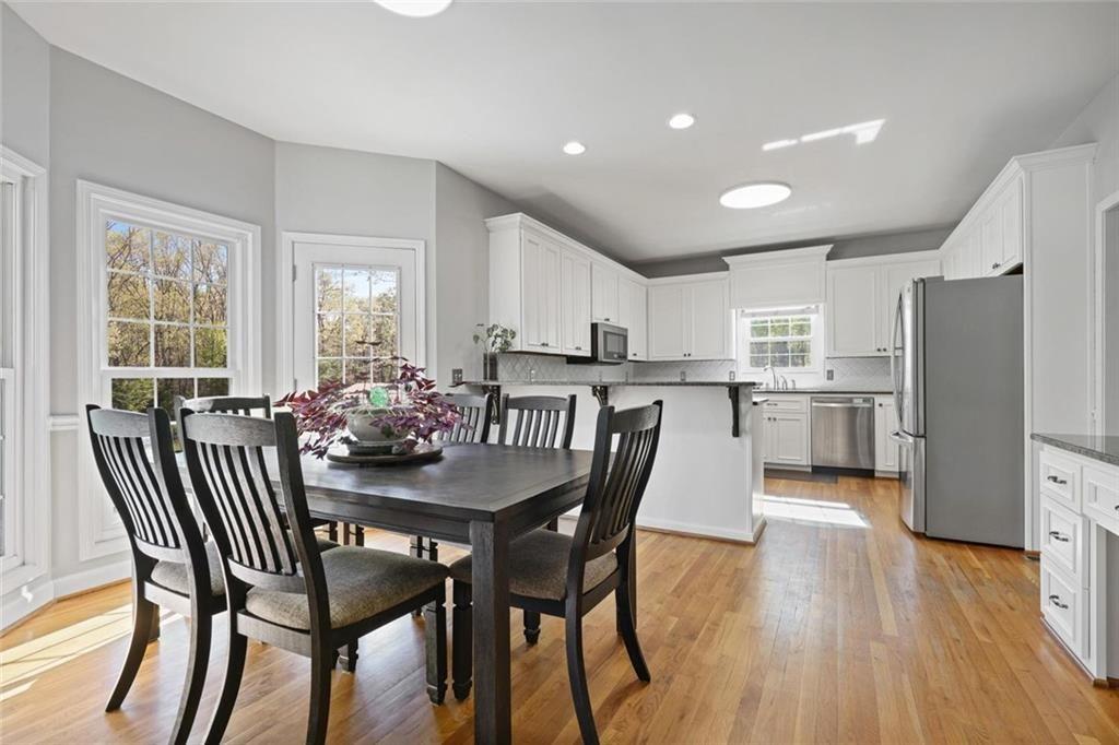 2203 Arbor Hill Road Canton, GA 30115 - Photo 32 of 65 a view of a dining room with furniture and wooden floor