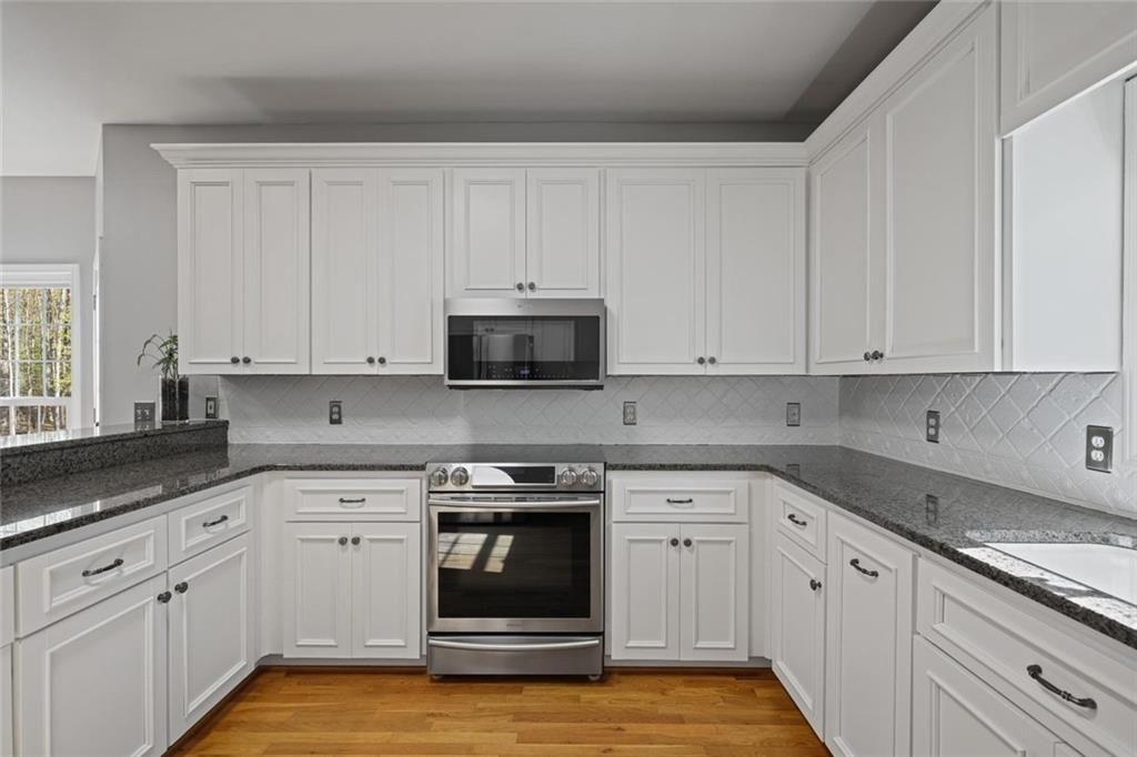 2203 Arbor Hill Road Canton, GA 30115 - Photo 36 of 65 a kitchen with white cabinets and white appliances