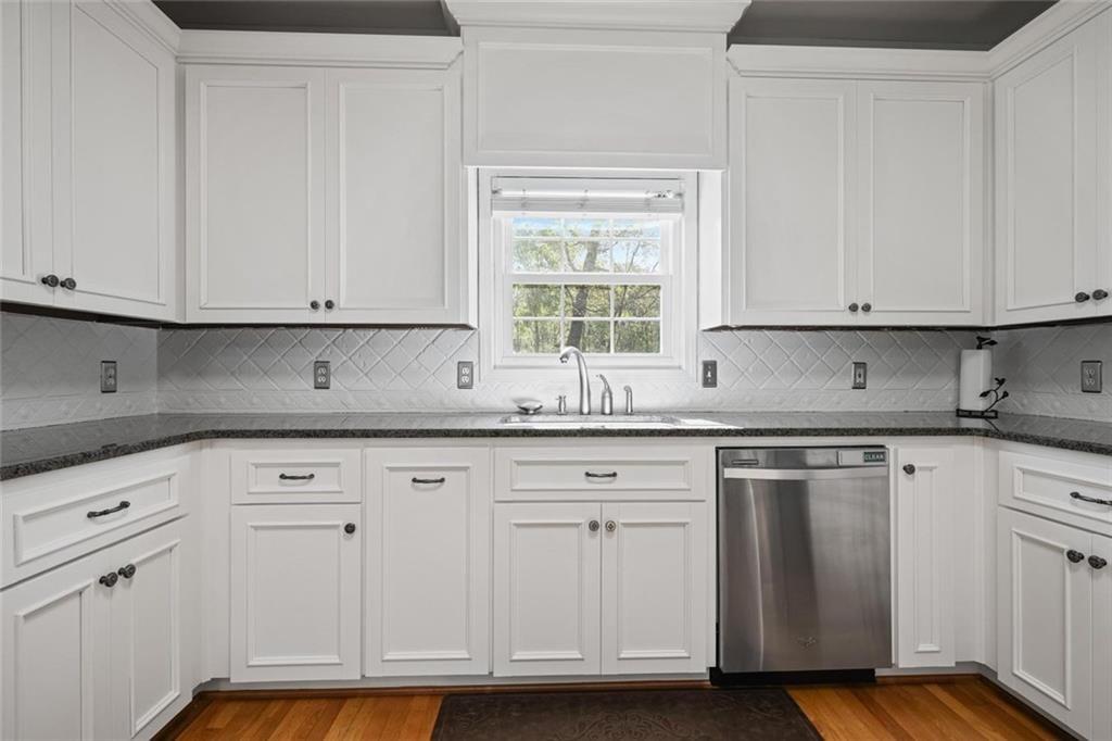 2203 Arbor Hill Road Canton, GA 30115 - Photo 37 of 65 a kitchen with granite countertop white cabinets and white appliances