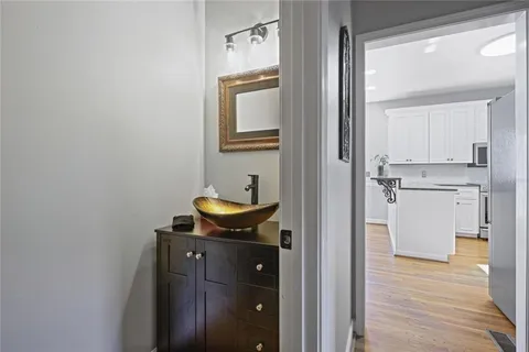 a room with gym equipment and wooden floor