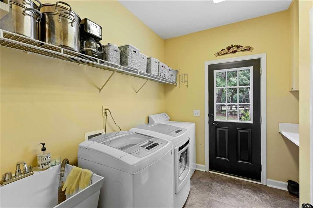 2203 Arbor Hill Road Canton, GA 30115 - Photo 40 of 65 a utility room with a sink a washer and dryer