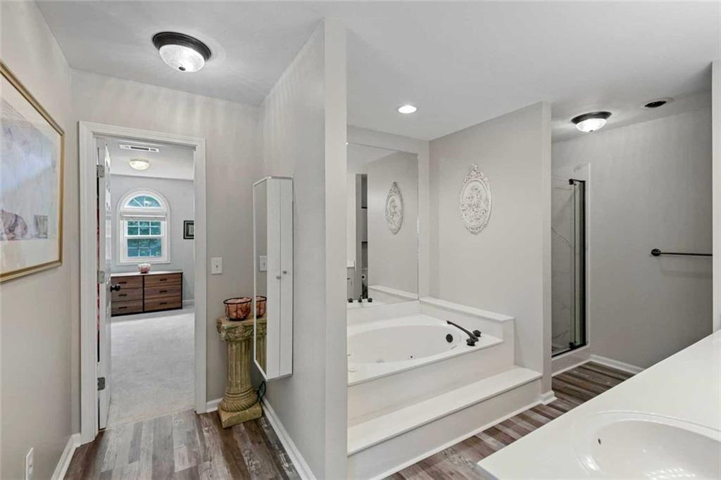 2203 Arbor Hill Road Canton, GA 30115 - Photo 42 of 65 a bathroom with a tub shower and sink