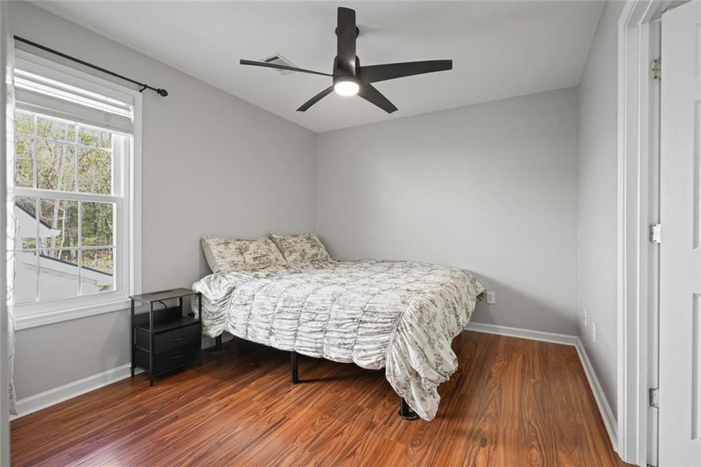 2203 Arbor Hill Road Canton, GA 30115 - Photo 45 of 65 a bedroom with a bed and wooden floor