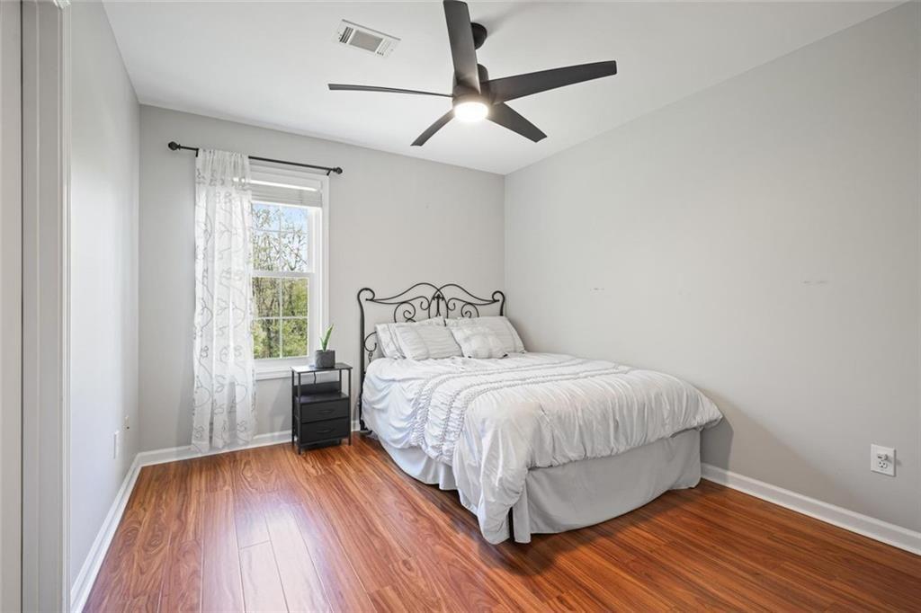 2203 Arbor Hill Road Canton, GA 30115 - Photo 48 of 65 a bedroom with a bed and wooden floor