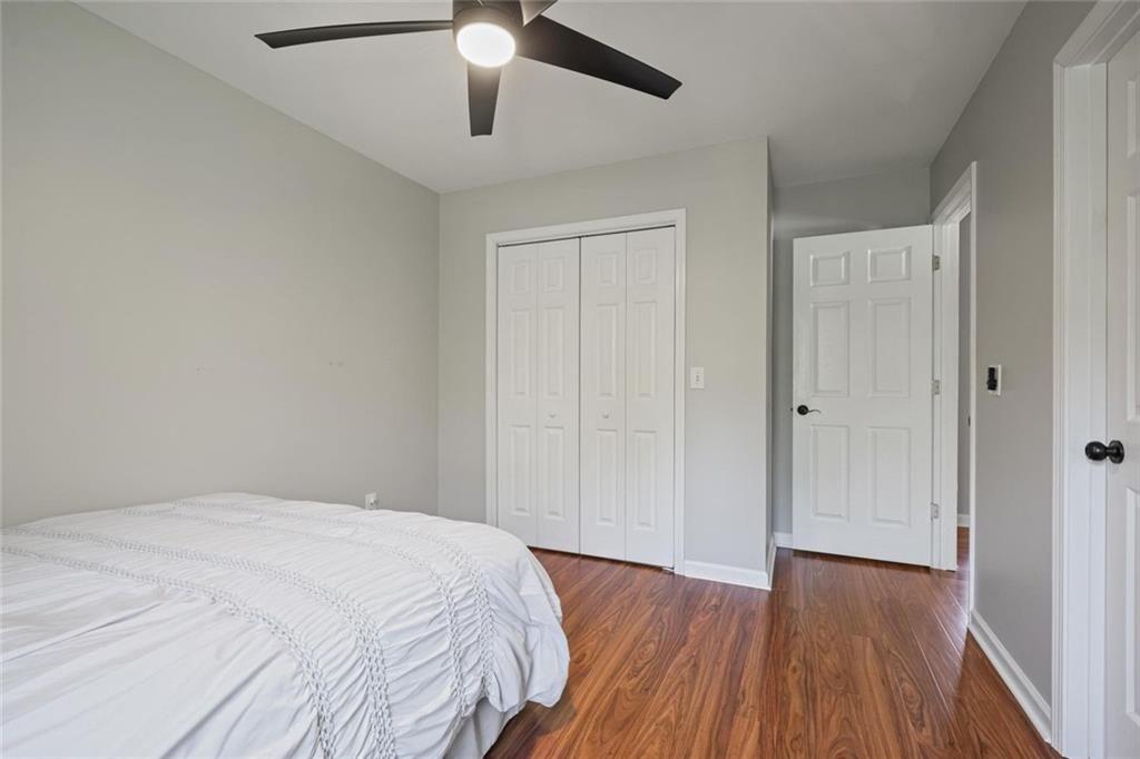 2203 Arbor Hill Road Canton, GA 30115 - Photo 49 of 65 a bedroom with a bed and a chandelier fan