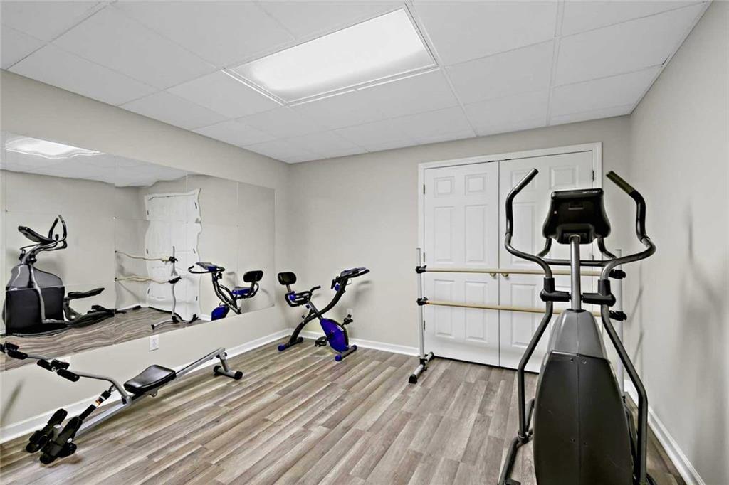 2203 Arbor Hill Road Canton, GA 30115 - Photo 53 of 65 a room with gym equipment and wooden floor