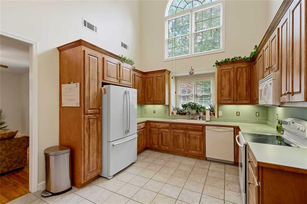 2203 Arbor Hill Road Canton, GA 30115 - Photo 58 of 65 a kitchen with stainless steel appliances granite countertop a refrigerator and a stove top oven
