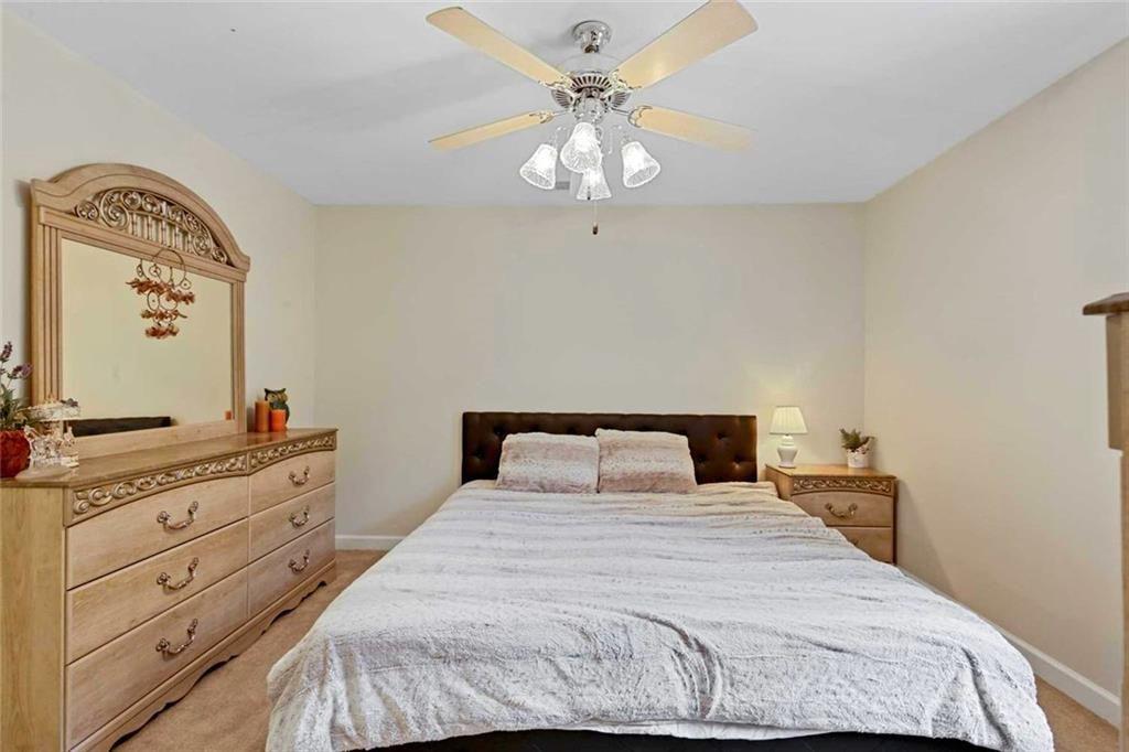 2203 Arbor Hill Road Canton, GA 30115 - Photo 63 of 65 a bedroom with a bed and a chandelier