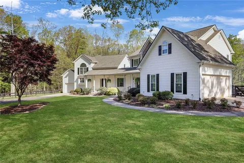 a view of a house with swimming pool and a yard