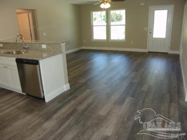 a view of a kitchen sink wooden floor and window