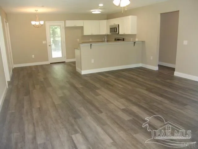 a view of a kitchen with wooden floor