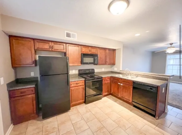a kitchen with a refrigerator sink and stove