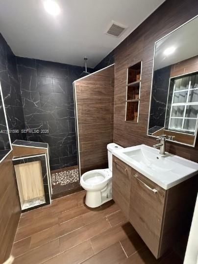 913 Northwest 46th Street, Unit 2 Miami, FL 33127 - Photo 7 of 7 a bathroom with a sink toilet and shower