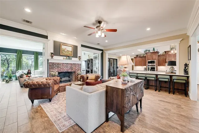 a bedroom with a large bed and a chandelier fan