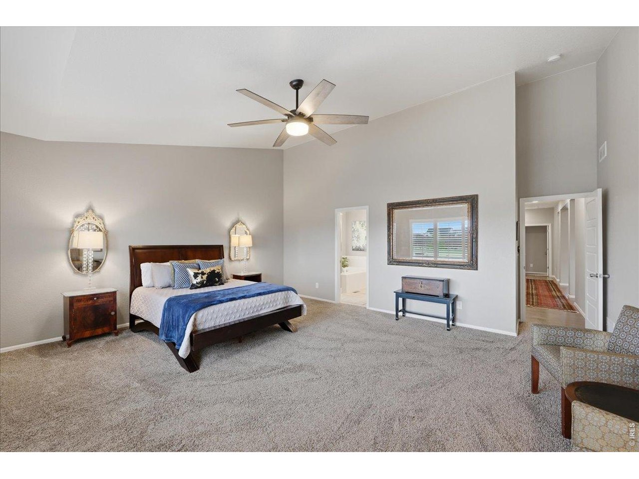 6096 Story Road Timnath, CO 80547 - Photo 17 of 50 a bedroom with a bed and a chandelier