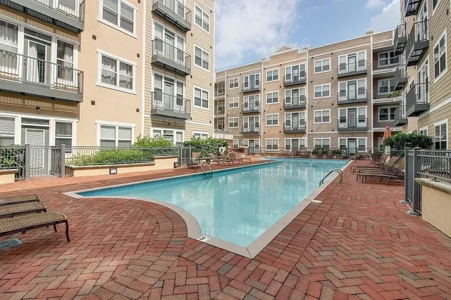 a swimming pool with outdoor seating and yard