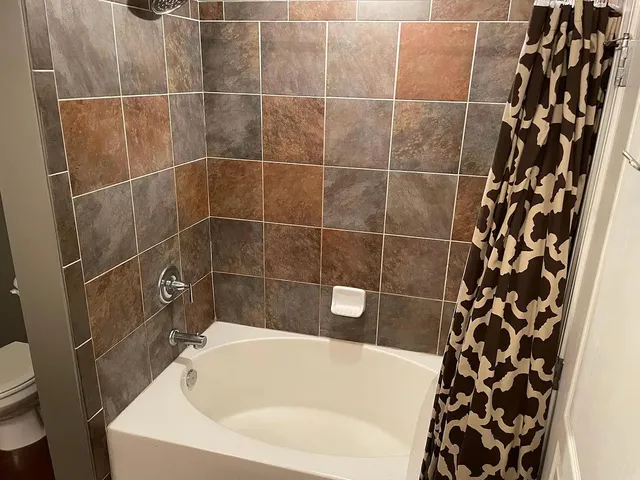 a bathroom with a bathtub and shower