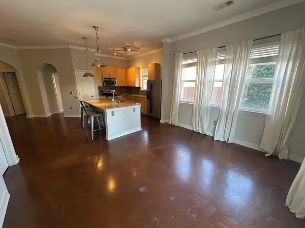 a view of kitchen with sink and refrigerator