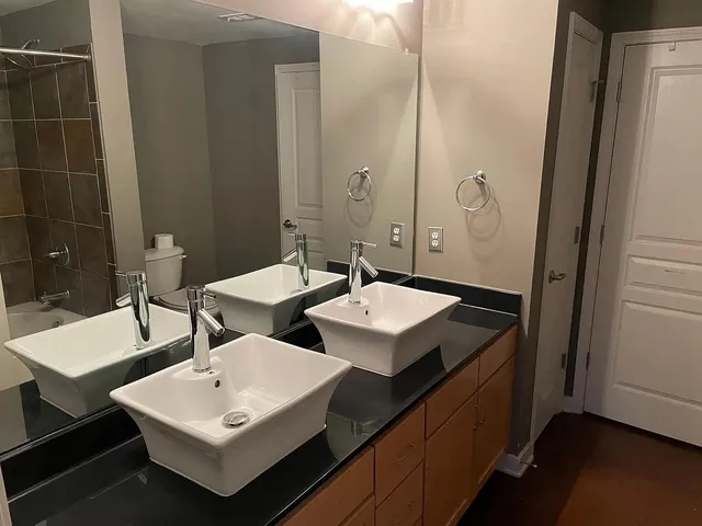 a bathroom with a double vanity sink and a mirror