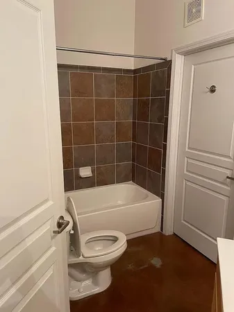 a bathroom with a toilet and shower