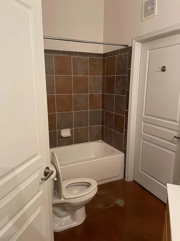 a bathroom with a toilet and shower