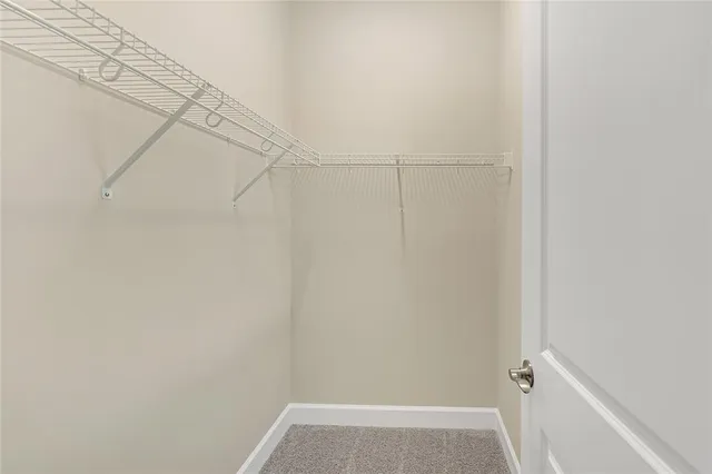 a bathroom with a granite countertop sink a mirror and a shower