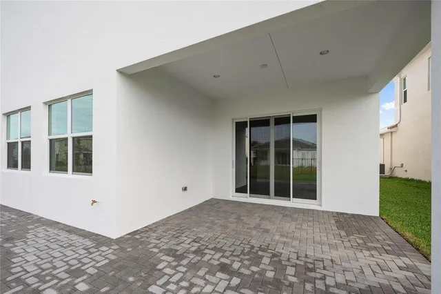 a white house with a yard and table and chairs
