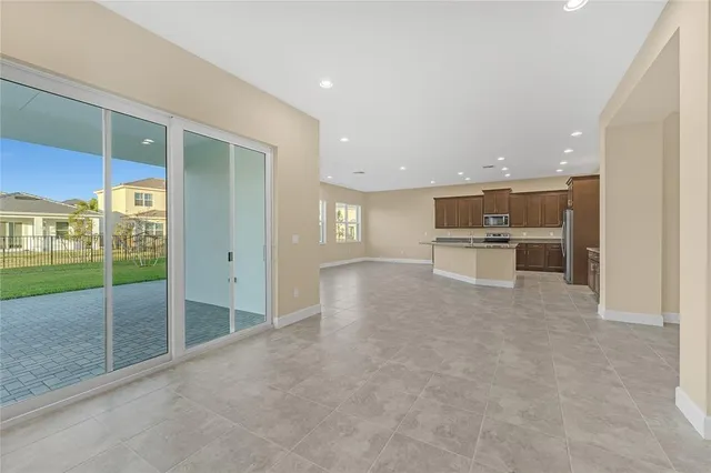 a view of kitchen with refrigerator and window