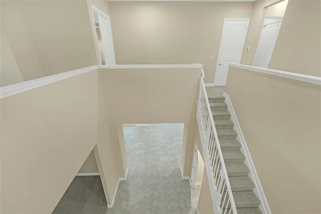 a view of staircase with white walls